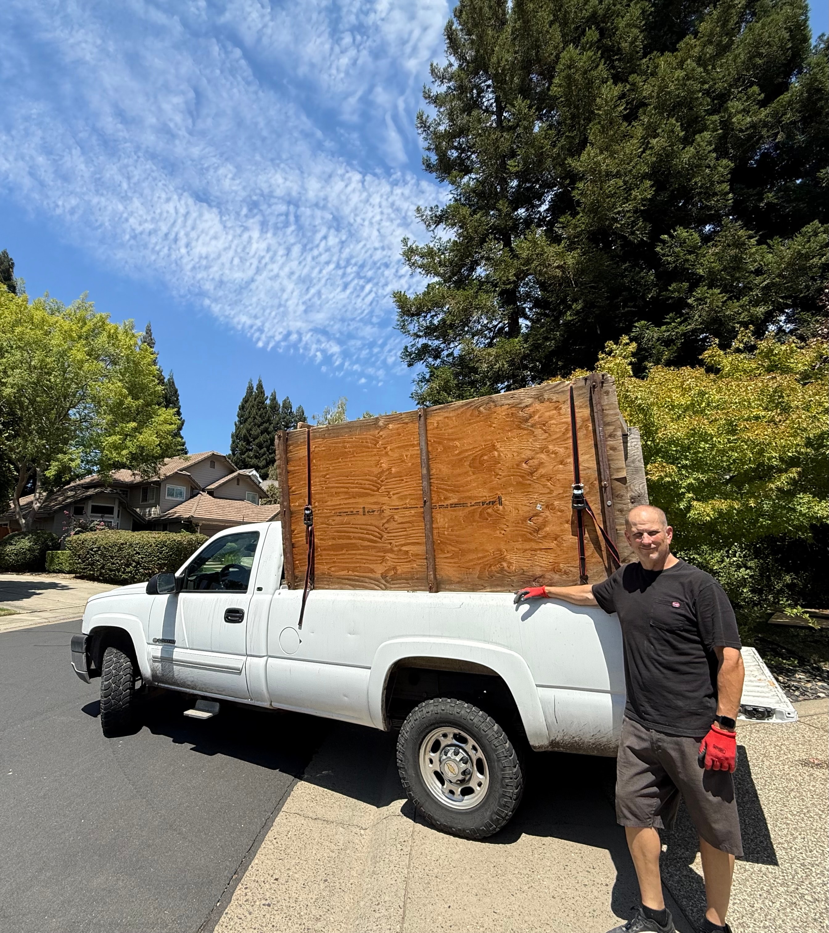 Same Day Service Hauling team member beside a pickup truck